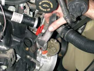 20. Grab the (EGR) tube and pull it out of the intake manifold as shown.