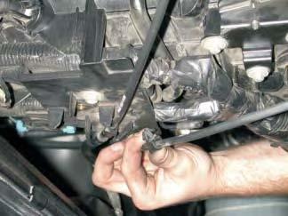Remove the throttle and cruise control cables from the plastic plate on top of the engine.