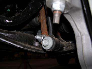 Install the boot over the strut and with one of the replacement washers, pull the boot over the washer at the top of the strut and