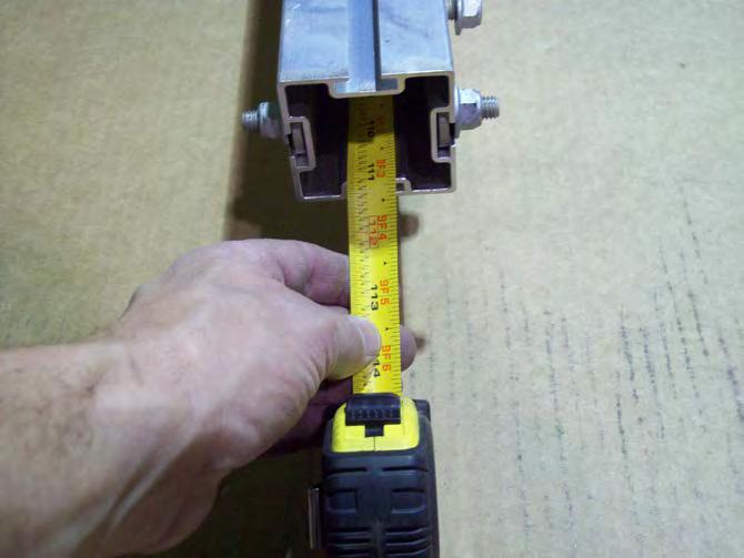 Extend a tape measure inside the tongue from the rear of the trailer until it
