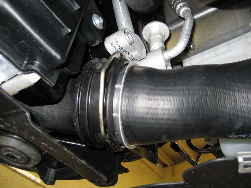 10. Working under the front of the car, remove both of the hoses that connect to the