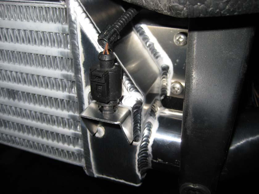 15. Offer the intercooler back up to the car, and make sure the holes line up, then screw the screws until they are all nearly tight,
