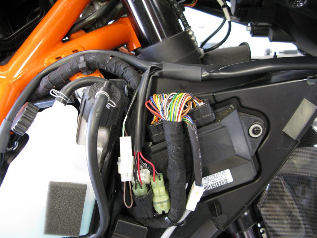 Prior to reinstalling the right side air inlet duct, route the remainder of the Bazzaz harness containing the control module toward the front of