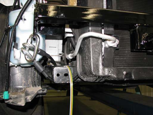 BX2632 20 20. Reconnect the windshield washer reservoir, using all the existing hardware which was previously removed.