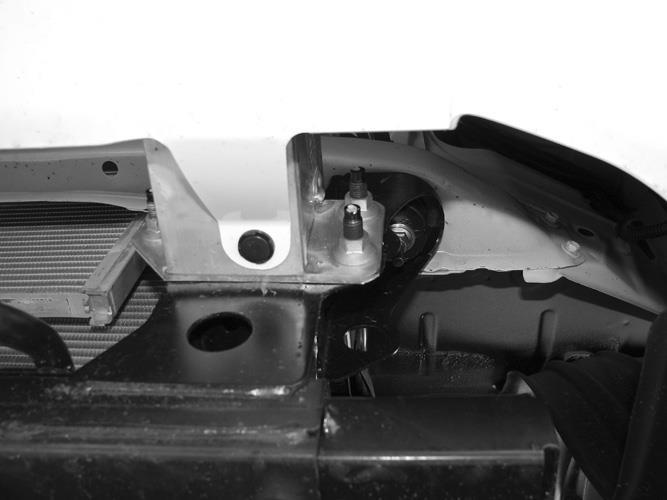 . Leave hardware loose. 6. With assistance, slide the complete Light Bar assembly through the openings in the bumper.