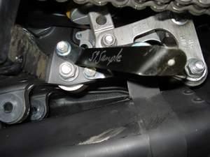 8) Use top mounting bolt of stock rear muffler mounting plate to attach to the left hand trim bracket.