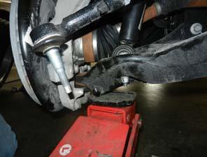7. Remove the brake line brackets and ABS wires from the knuckle and frame using 8, and 10mm sockets.