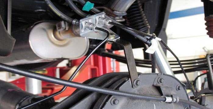 2) Carefully reshape the OE hard brake lines and twist the plastic brake line retainers on the axle to allow OE brake line bracket to attach to RS170014.