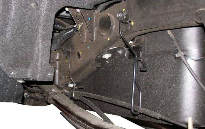 NOTE: On some models, brake line bracket RS170014 may need to be bent up and back to connect OE brake bracket Illustration 29 RS170014 3) Remove the driver side (lower) parking brake cable from the