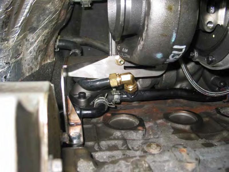 On standard transmission equipped vehicles, you will not need to install this fitting. Just bend the coolant line enough to be able to install the turbo support bracket. View from below.