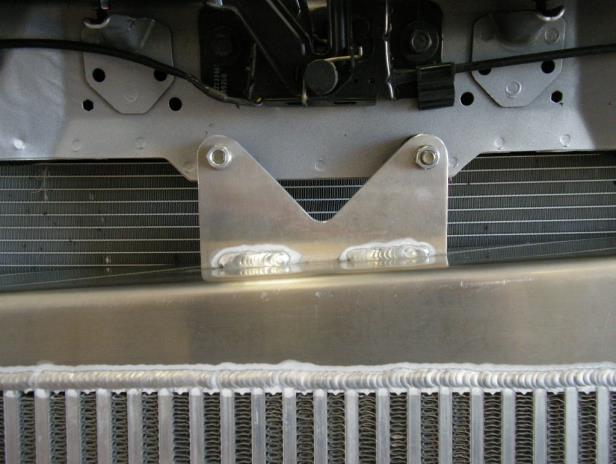 Install the intercooler by sliding the inlet sleeve between the