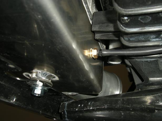 6. Mount the intercooler to the bottom of the core support as shown using large flat washers and the two