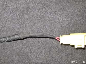 Apply electrical tape to the corrugated cover and wires as shown.