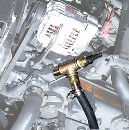 Route the hose to the thermostat housing. Tie down hose as required to ensure that it does not interfere with controls, levers, accessories, or any other moving or hot parts.