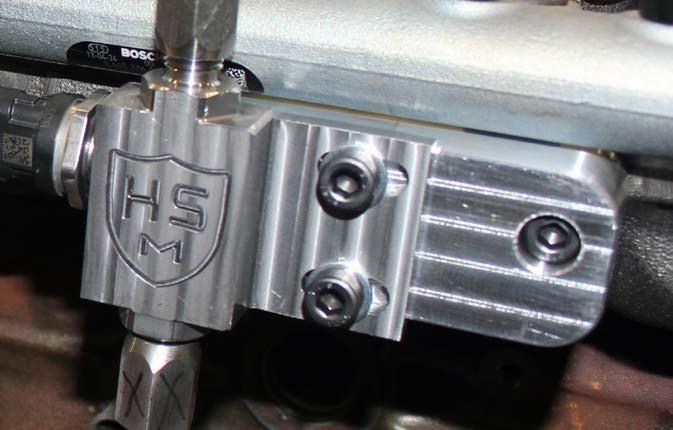 Loosely install the fuel distribution block onto the previously installed mounting block using the M8 hardware as shown.