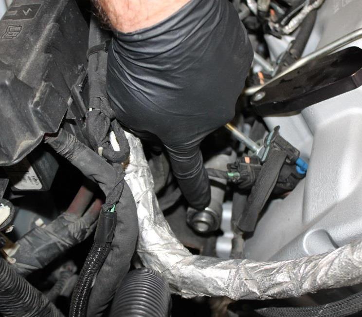 Locate passenger side fuel rail, located above valve cover.