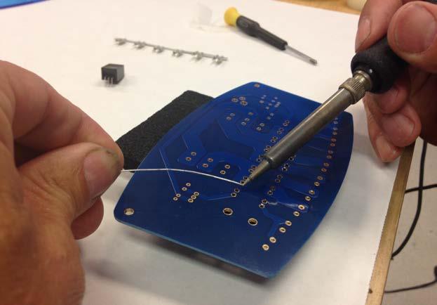 Insert the capacitors into their designated holes on the board. As you install these capacitors, spread the leads slightly (see image, right).