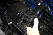 If the car has a shock tower brace, remove it for the time being. 2) Remove the lower splash pan from under the engine.