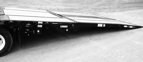 2. Park trailer and tow vehicle on firm level ground insure brakes are applied. Insure ramp lowering area is clear. Remove ramp securing chains. 3.