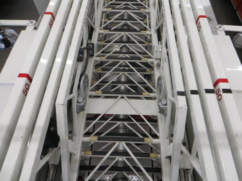 While the aerial ladder is fully retracted and bedded, the driver can place ½-inch or 1-inch strips of black electrical tape in-line on the top of each beam (rails) of the ladder.
