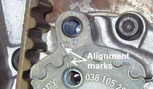 From above, loosen the 15mm nut on the tensioner and use the tensioner tool to adjust the
