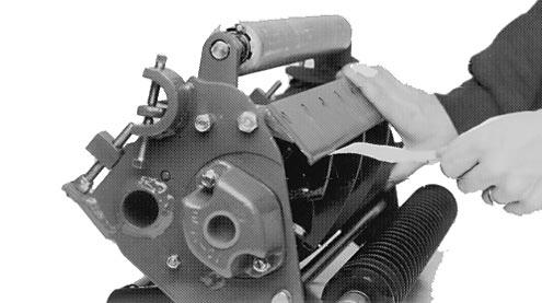 First, loosen the bottom screw on each side of the cutting unit (Fig. 1), then tighten the top adjustment screw on each side of the cutting unit.
