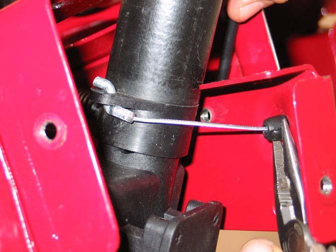 Remove spring from transmission actuating arm. (This is the self propel clutch cable) See Figure 3.17.