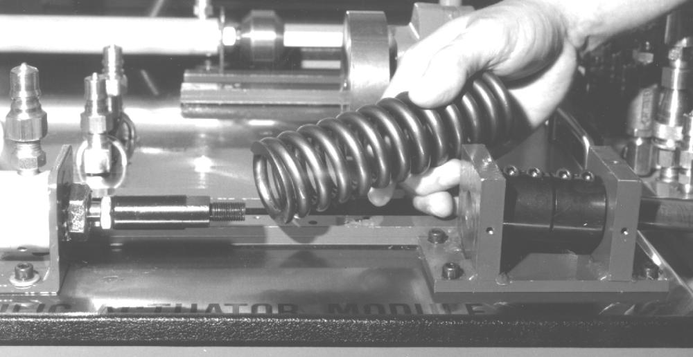 G. Remove the load rod from the cam and slide it to the right until the threads are flush with the load block, as shown in figure 13. H.