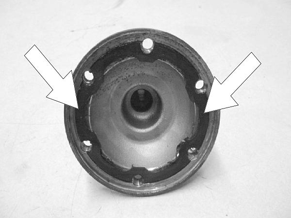 Thoroughly clean the output flange to C/V joint surfaces of all buildup, deposits, and grease as pictured.