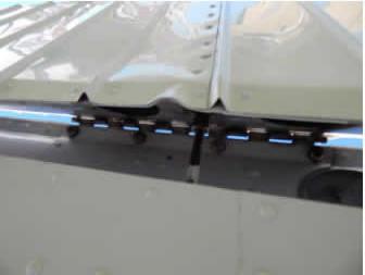 Inspect the aileron surface above and below for damage. Check the aileron for freedom of movement.