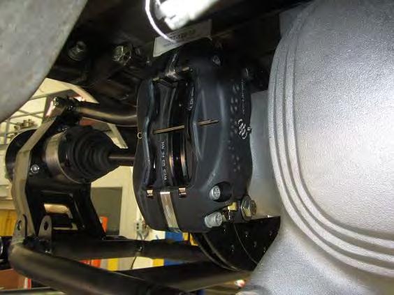 Use the shim washers to space the caliper so the brake pads sit equal distance from the brake rotor.