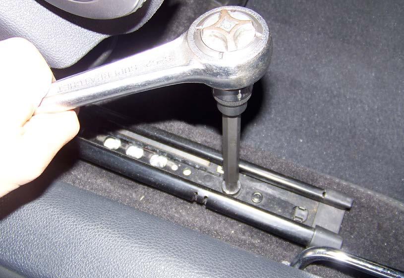two bolts that hold the seat rails to the body of the car.