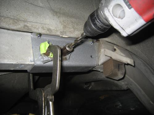 Inset picture shows reinforcing sandwich plates installed in trunk area. Drill the 3/8 inch holes through the frame using the channel bracket as a guide.
