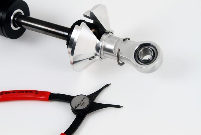 51. Assemble the coilover shock by removing the snap ring using a set of snap ring pliers to remove the upper