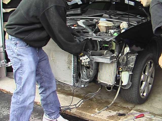 Pull radiator support away from car, taking care not to