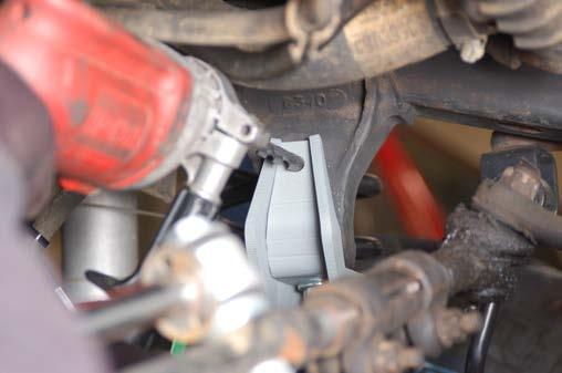 54.Remove the stock front brake line from the metal line at the frame rail using a 3/8 wrench.