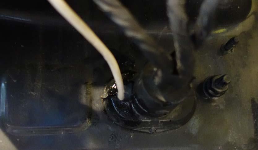 Use some silicone sealant to seal around the cable to prevent any water getting into the car.