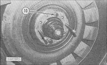 16. Install two bolts (10) to secure the inboard idler wheel during the belt removal. 17. Install two bolts (12) to secure the inboard drive wheel during the belt removal. 18.