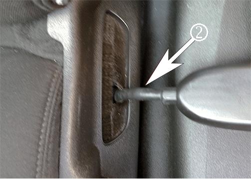 Bend the seat belt cable toward the inside (1) and