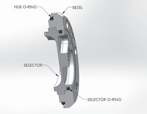Apply o-ring lube to the o-rings and assemble them onto the selector and bezel as shown. Note: The installed driver must have less then 0.