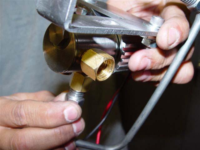 Remove left master cylinder nut from master cylinder and unscrew front brake line (line closest to nut that was removed).