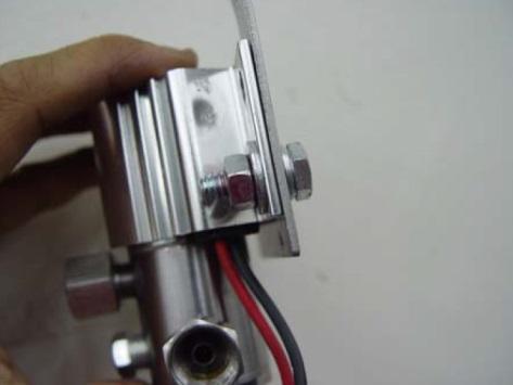 2. Attach mounting bracket to solenoid as shown in step 2 and 3. Add a few drops of Loctite (red) to bolt threads.
