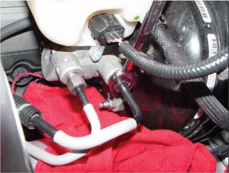 Add clean rags under Master Cylinder in order to keep fluid from spilling on vehicle.