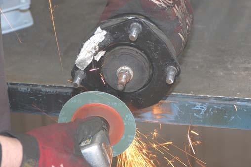 Using a hand grinder or similar tool, grind the unthreaded tip portion of the factory stud to allow