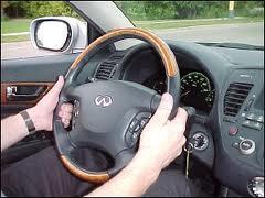 positioning both hands on the steering wheel at 9:00 and 3:00 or 8:00 and 4:00.
