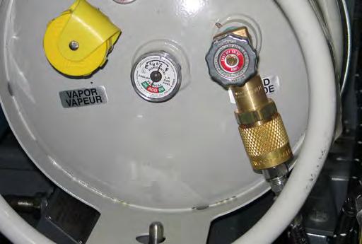 OPERATION CHANGING THE LPG TANK 6. Disengage the mounting strap and remove the empty LPG fuel tank.