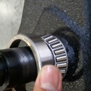 You may need to sand down the shaft, if the coating is too thick, so you can slide bearing all the way to the bottom of the axle.
