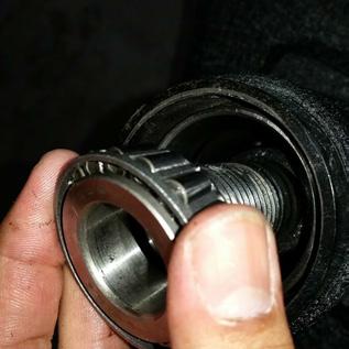 Now drop in the race from the smaller bearing, fat-side down, followed by the bearing itself just as shown in first picture below.