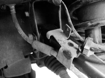 FIGURE 2 6. Disconnect the brake line bracket from the upper control arm. Hardware will not be reused. 7.