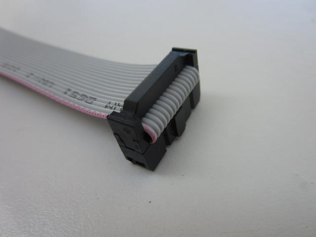Fold the cable over the top of the connector and insert the train relief clip until it latches on both sides.